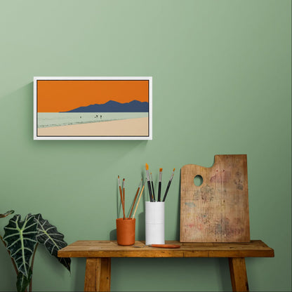 The framed 'Let's Go to the Beach' canvas print styled above a table, highlighting the vibrant orange and soft green hues of the sea.