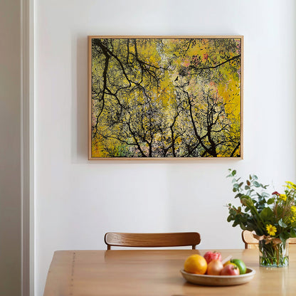 Fine Art Canvas Print titled Soar by Norma Slack featuring abstract yellow sky and birds seen through tree branches. Shown in a dining room setting.